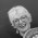 White-haired woman laughing at the camera